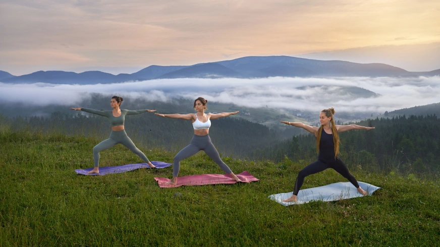 sporty women doing yoga exercises nature