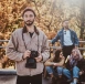 attractive hipster glasses is posing photographer with photo camera while his friends are resting background_613910 3511